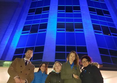 Confederation Building was lit blue for Child Abuse Prevention Month. Minister Parsons poses with volunteers from Miles for Smiles Foundation (2018)